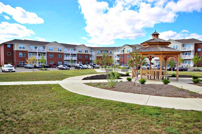 exterior view of the Commons at Little Bark Creek Apartments in Fremont, Oh with a gazebo and trees